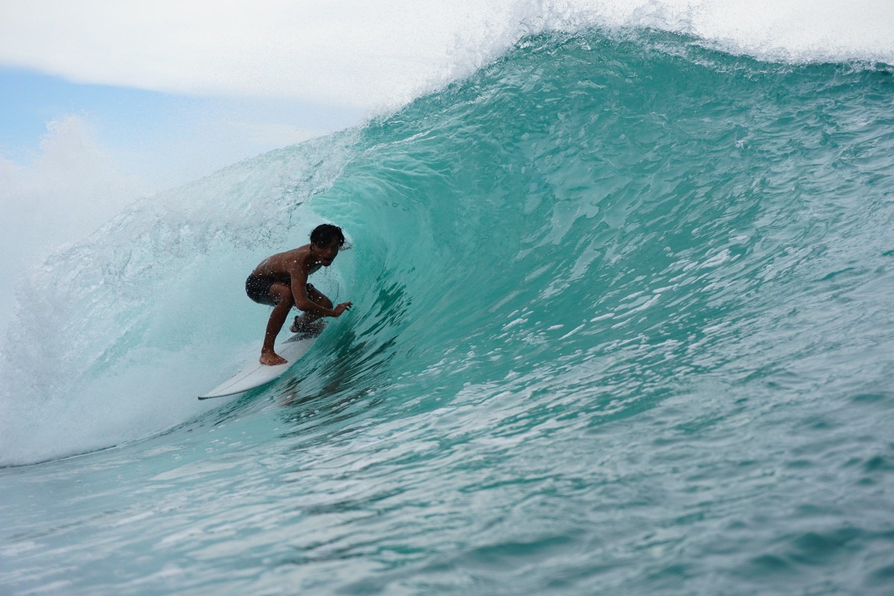 Arik surfing a barrel on the Bukit